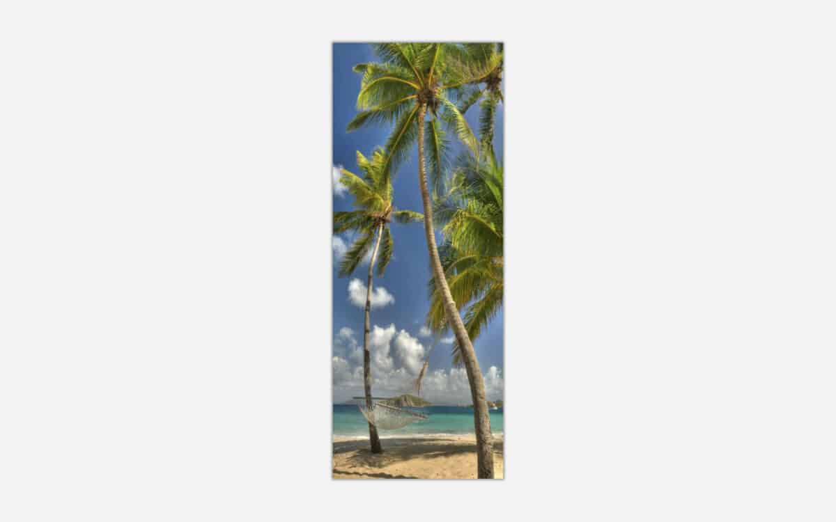 A vertical canvas art print featuring a tropical beach scene with palm trees, a hammock, and a clear view of the blue sky and ocean.