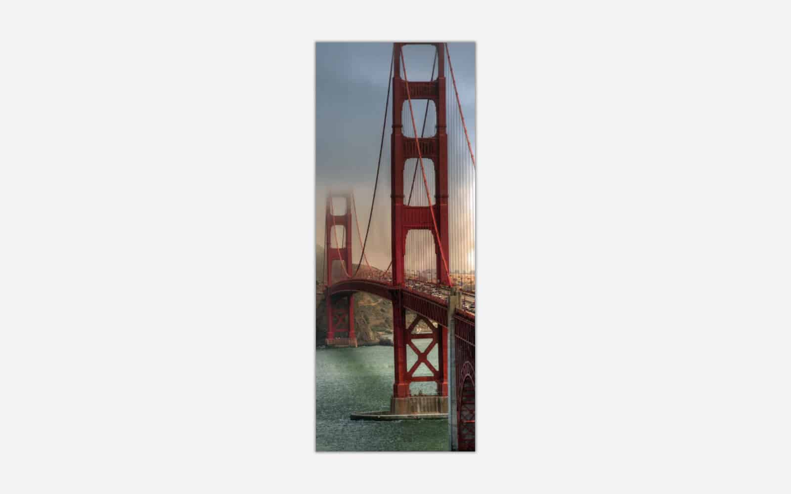 Golden Gate Vertical (1) A panoramic wall art canvas featuring the Golden Gate Bridge in San Francisco during sunset with warm lighting and coastal elements.