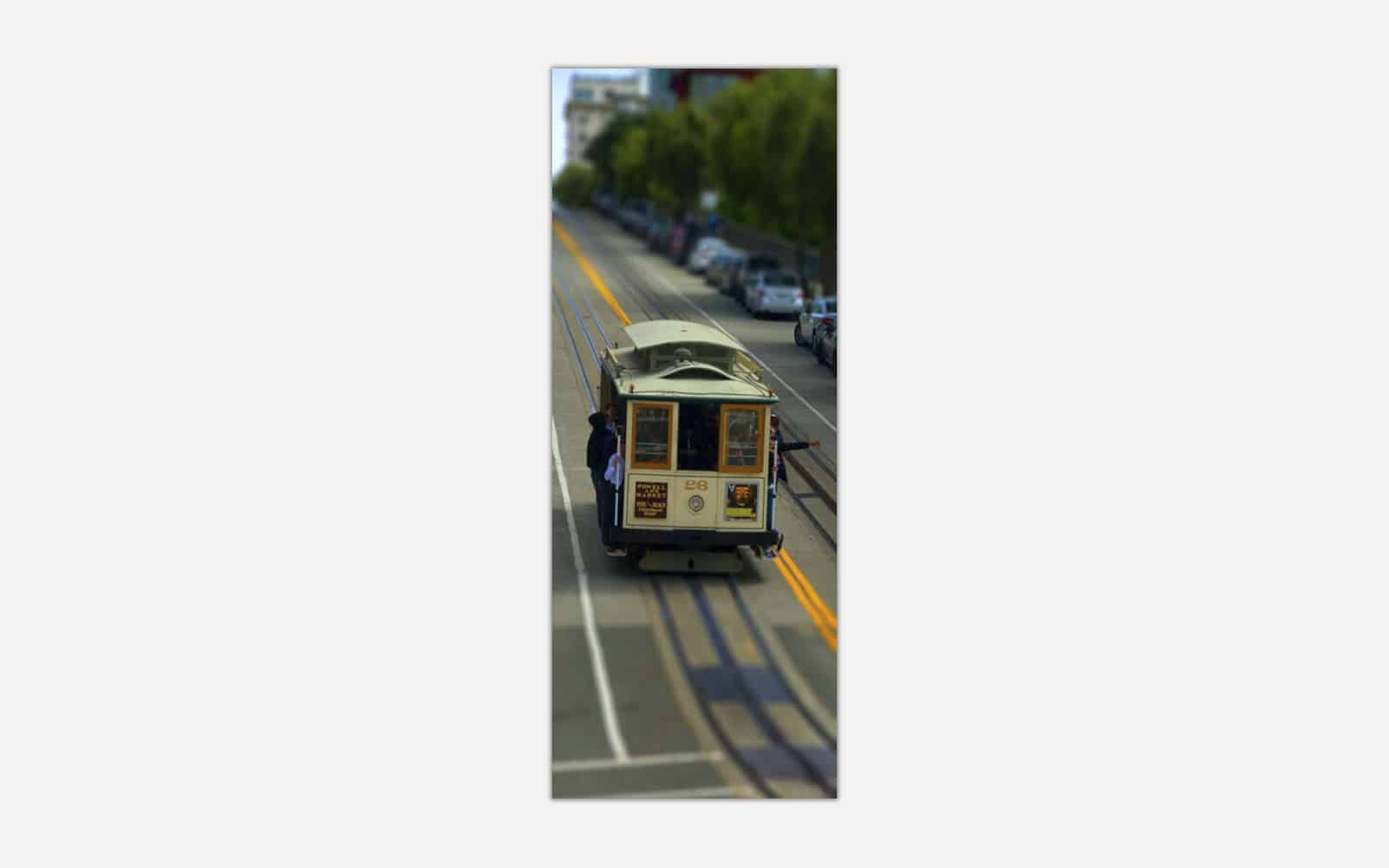 Hyde Street Trolley (1) A tilt-shift photograph of a classic San Francisco cable car on the streets with blurred surrounding details giving a miniature effect.