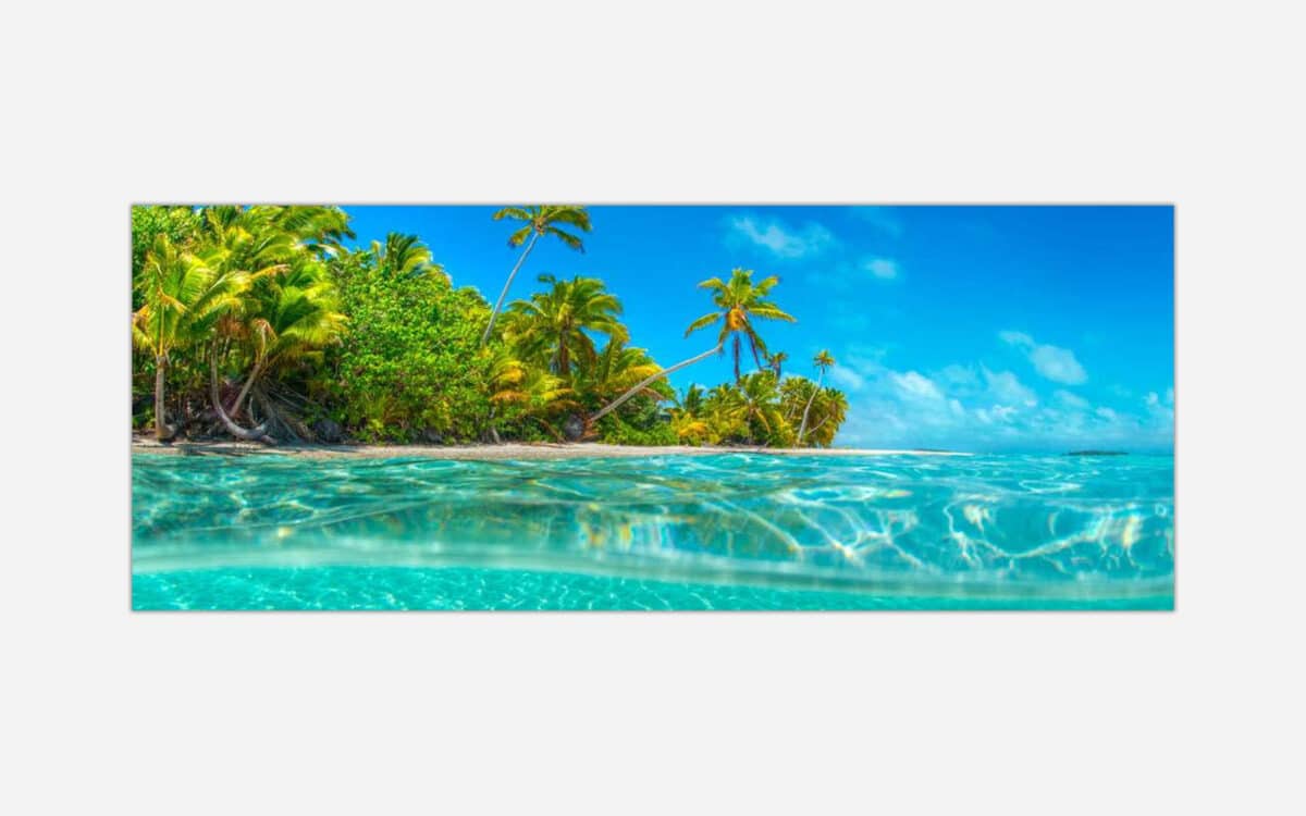 Alt text: Artistic representation of a tropical paradise with clear turquoise waters, white sandy shoreline, and dense palm trees under a bright blue sky.