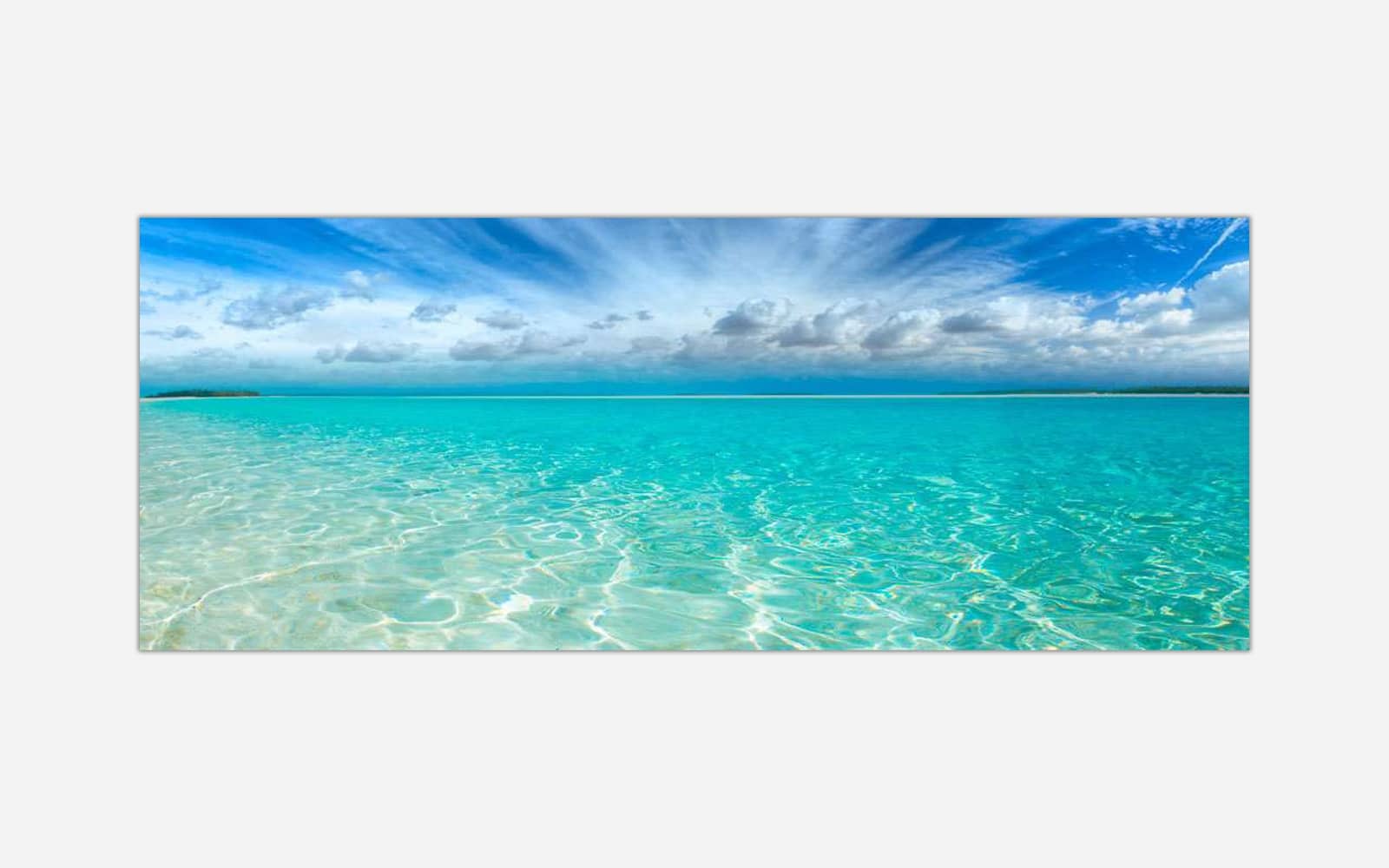 Sea and Sky (1) A canvas print featuring a serene tropical beach scene with clear turquoise water and a blue sky with scattered clouds.
